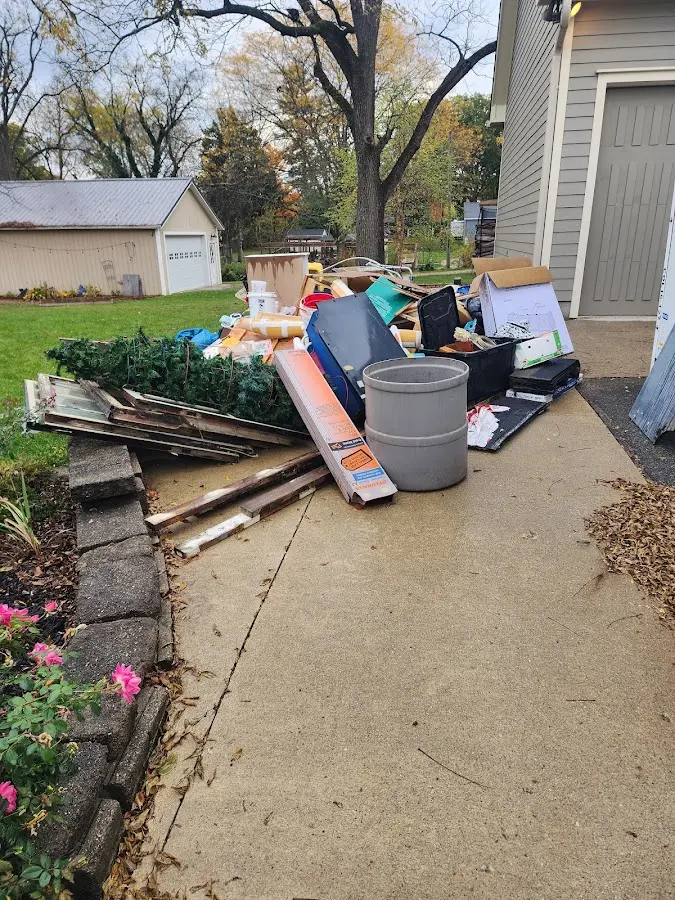 Dumpster being loaded with debris for 3 Yard Dumpster Rental in Lawrence